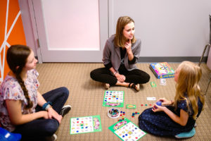 Basal therapist playing games with children