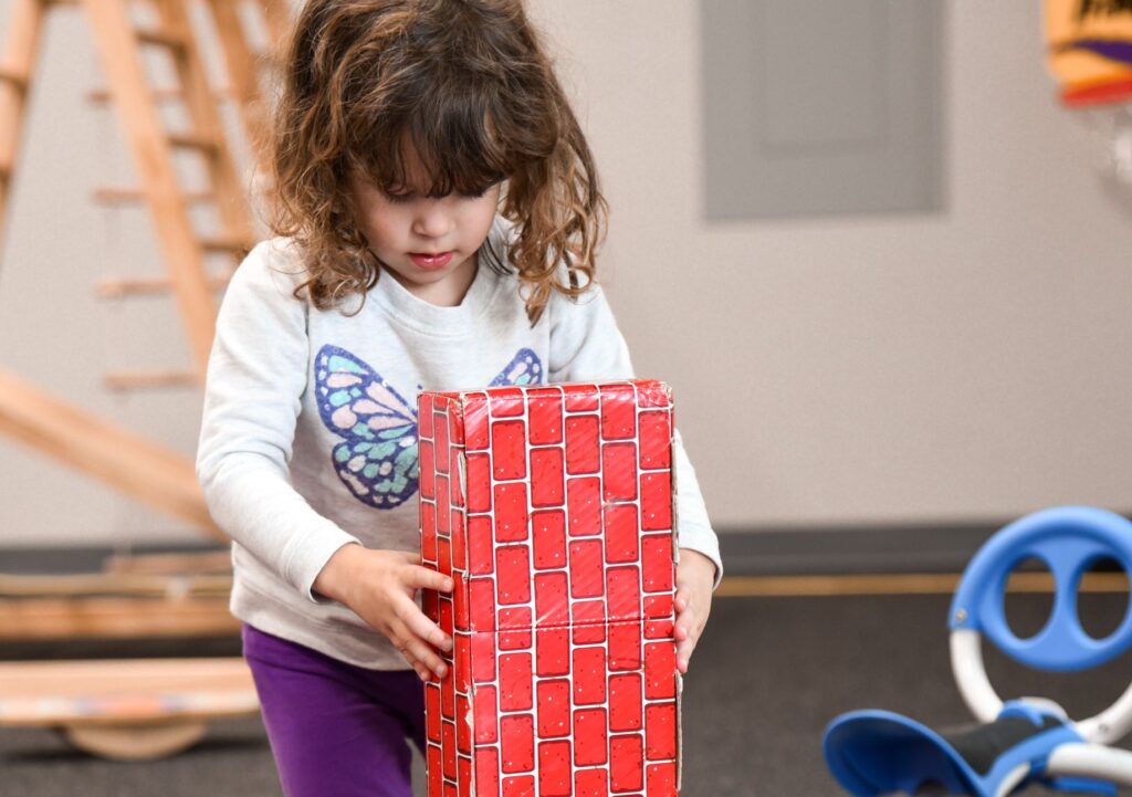young child stacking blocks