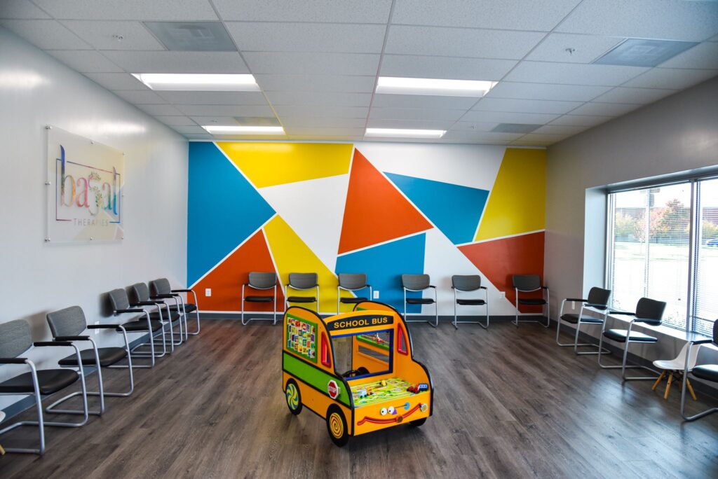 Basal Preschool waiting area with chairs and children's toy school bus