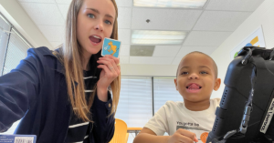speech therapist using aac with child