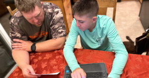 father providing homework help for his son