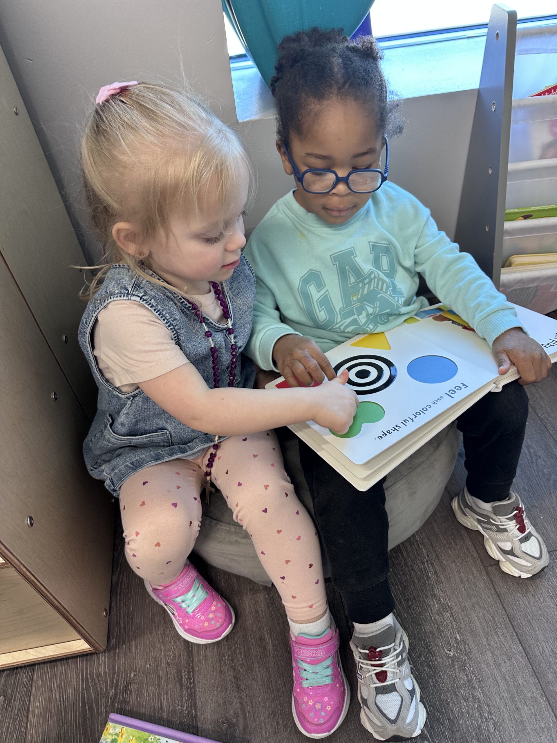 Two toddlers building social skills through inclusive play