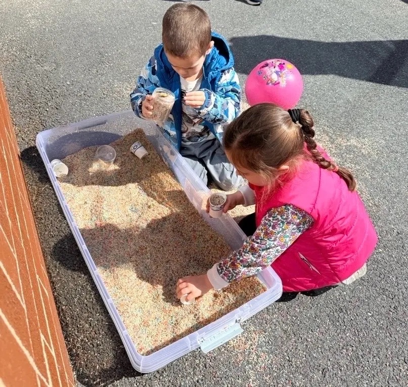 Two toddlers experiencing the benefits of summer camp
